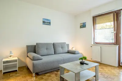 a living room with a couch and a table at Apartmaji Anja in Bled