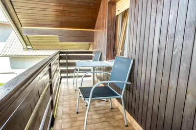 two chairs and a table on a balcony at Apartmaji Anja in Bled