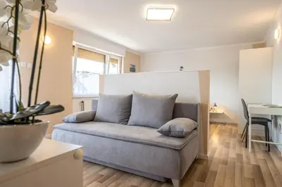 a couch in a living room with a table at Apartmaji Anja in Bled