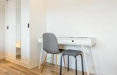 a white desk with a chair and a mirror at Apartmaji Anja in Bled