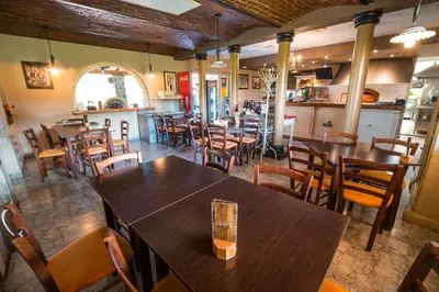 a restaurant with tables and chairs in a room at Guesthouse Mars in Ig