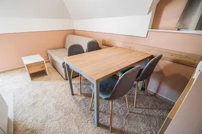 a room with a table and chairs and a couch at Guesthouse Mars in Ig