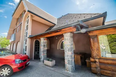 a house with a car parked in front of it at Guesthouse Mars in Ig