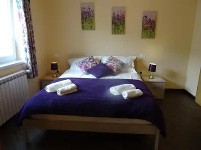 a bedroom with a bed with two towels on it at Kramer Hiša in Kobarid