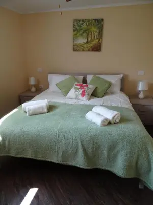 a bedroom with a large bed with towels on it at Kramer Hiša in Kobarid