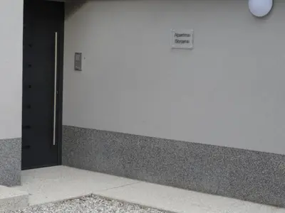 a door to a building with a sign on it at Kramer Hiša in Kobarid