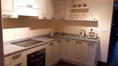 a kitchen with white cabinets and a sink at Kramer Hiša in Kobarid