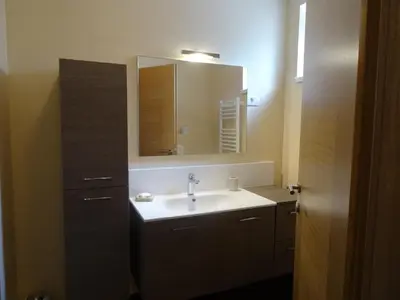 a bathroom with a sink and a mirror at Kramer Hiša in Kobarid