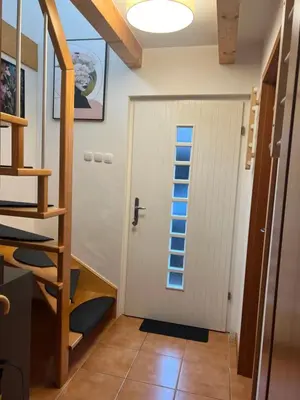 a door with a window in a room with a staircase at Bella Mura Nature House I26 in Podčetrtek