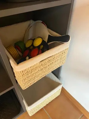 a basket filled with colorful rocks in a drawer at Bella Mura Nature House I26 in Podčetrtek