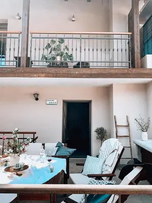 two images of a balcony with a table and chairs at Pr' Kramarju - House in the heart of Kobarid in Kobarid
