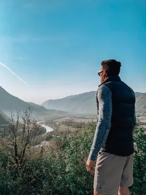 a man standing on a hill looking at a valley at Pr' Kramarju - House in the heart of Kobarid in Kobarid