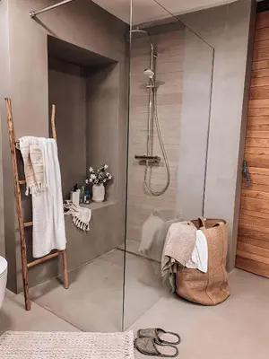 a shower with a glass door in a bathroom at Pr' Kramarju - House in the heart of Kobarid in Kobarid