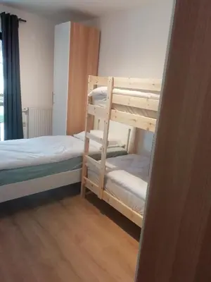 a bedroom with two bunk beds and a window at CARNIOLAN HOUSE - GORENSKA HIŠKA in Radovljica