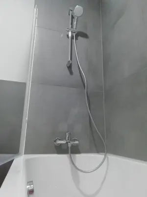 a shower with a faucet in a bathroom at CARNIOLAN HOUSE - GORENSKA HIŠKA in Radovljica
