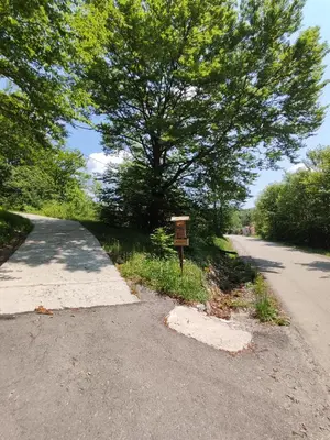 a sign on the side of a road next to a tree at Guest House Nanos in Vipava