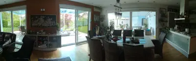 a living room with a table and chairs and sliding glass doors at Homestay Free Park&Bikes in Ljubljana
