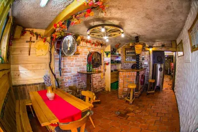 a room with a table and a brick wall at Vinska klet Smej in Lendava