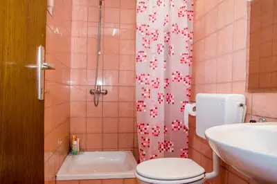 a bathroom with a toilet and a sink and a shower at Vinska klet Smej in Lendava