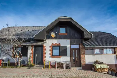 a house with a table and chairs in front of it at Vinska klet Smej in Lendava