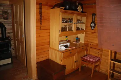 a kitchen in a cabin with a counter and a stove at Estate Marjetin dom in Idrija