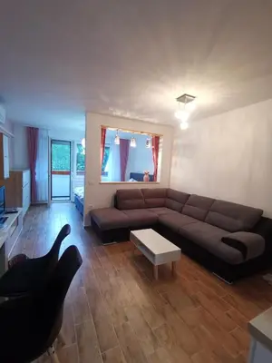 a living room with a brown couch and a table at Apartma F&M in Bovec