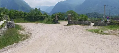 a dirt road with mountains in the background at Apartma F&M in Bovec