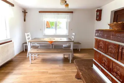 a dining room with a table and chairs and a window at Domačija Vesel in Trebnje
