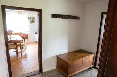 a room with a room with a table and a wooden chest at Domačija Vesel in Trebnje