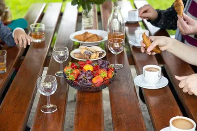 a table with a bowl of fruit and a bowl of food at Domačija Vesel in Trebnje