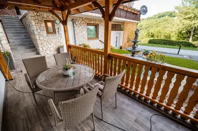 a patio with a table and chairs on a deck at Apartments Stankovo in Krška Vas