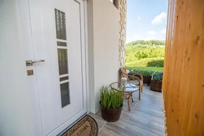 a door to a balcony with a table and chairs at Apartments Stankovo in Krška Vas
