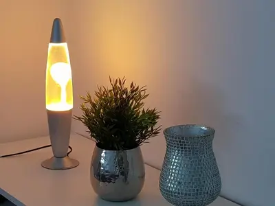 two vases on a table with a lamp and a plant at Apartments Stankovo in Krška Vas