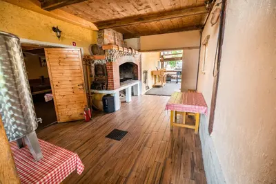 a living room with a fireplace and a table at Apartment with Sauna pr' Geči in Dobova