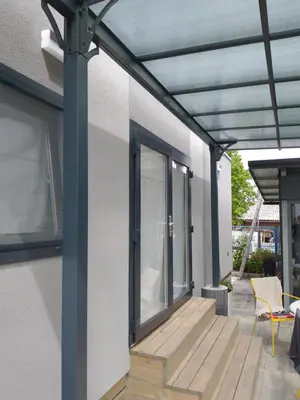a pergola on a house with a wooden deck at Apartments Drevi in Ljubljana