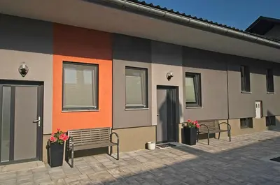a facade of a building with benches and windows at Apartments Drevi in Ljubljana