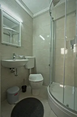 a bathroom with a toilet and a sink and a shower at Apartments Drevi in Ljubljana