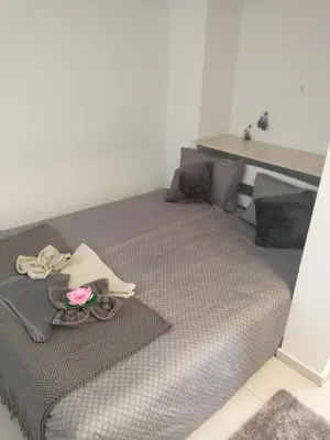 a bedroom with a bed with a flower on it at Apartments Drevi in Ljubljana