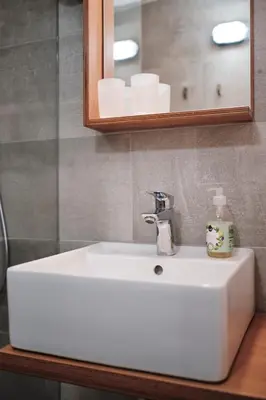 a white sink in a bathroom with a mirror at Apartment Center in Kamnik
