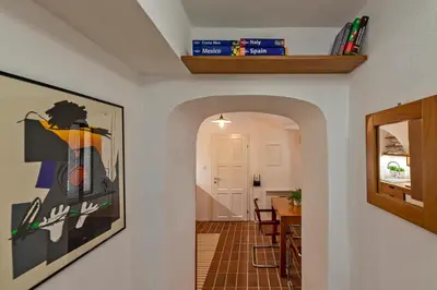 a hallway leading to a dining room and kitchen with a painting on the wall at Apartment Center in Kamnik