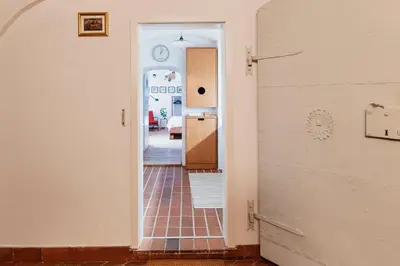 a hallway leading into a kitchen with a door open at Apartment Center in Kamnik