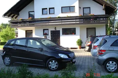 a black car parked in front of a house at Tiffany Pension Bled in Bled