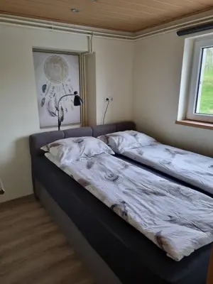 a large bed in a room with a window at NA OFF in Radenci