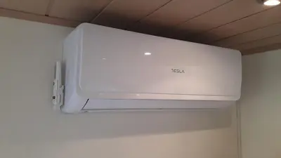 a white air conditioner hanging from a ceiling at NA OFF in Radenci