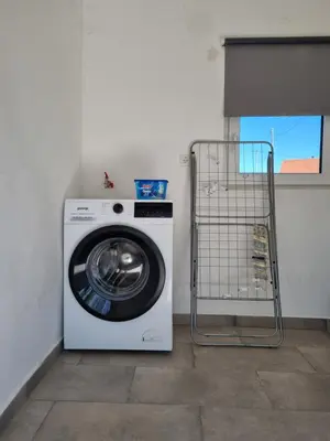 a washing machine with a cart next to it at NA OFF in Radenci