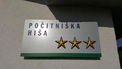 a sign on a wall with three gold stars at NA OFF in Radenci