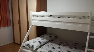 a white bunk bed with a pillow in a room at VILLA ČEH in Gabrovica pri Črnem Kalu
