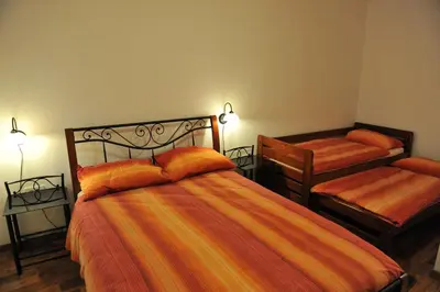 a bedroom with two beds and two night stands at Apartmaji Kumar in Šmartno