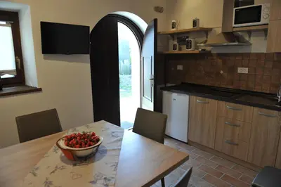 a kitchen with a table with a bowl of fruit on it at Apartmaji Kumar in Šmartno