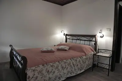 a bedroom with a bed with two pillows on it at Apartmaji Kumar in Šmartno